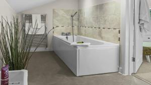 a white bathroom with a tub and a sink at Whitedown in Alton