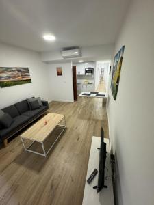a living room with a couch and a table at Benicasim Village by Tucasanlaplaya in Benicàssim +33 photos