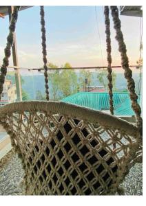 a rope swing with a view of a pool at Triveni Stays Blue Gum 3BHK in Panchgani
