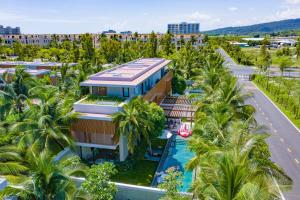 an aerial view of a resort with palm trees at Sailing Pool Villas & Resort Phu Quoc in Phú Quốc