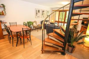 a living room and dining room with a spiral staircase at Cedar Holiday Units - Apartment 3 in Bright