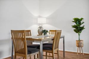 a dining room table with two chairs and a plant at Perth Prime Located 2BDR 1PRK in Perth