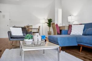 a living room with two blue couches and a table at Perth Prime Located 2BDR 1PRK in Perth