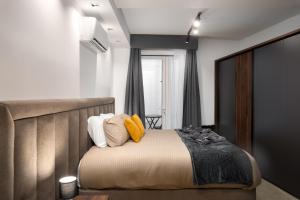 a bedroom with a large bed with yellow pillows at Modern 1BR Maisonette with Back Yard - Close to Manoel Island Saint Julians & Tigne Shopping Mall in Il-Gżira