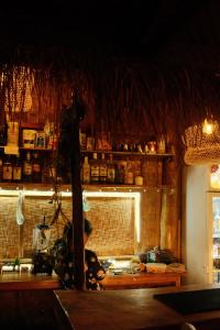 a man in a kitchen preparing food in a kitchen at Jungle KingDomes Guest House in Siquijor +65 photos