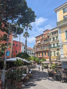 a city street with tables and chairs and buildings at Casa Moret in Sanremo