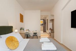a bedroom with a bed with a yellow pillow on it at M18 Studios Monastiraki Gems in Athens