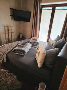a bed with towels on top of it with a window at Ferienwohnungen & Landlust Fulda in Petersberg +40 photos