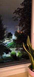 a window with a view of a city at night at Apartament Opawska in Racibórz