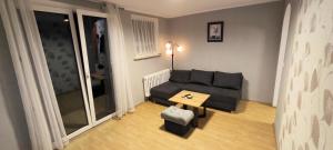 a small living room with a couch and a table at Apartament Opawska in Racibórz