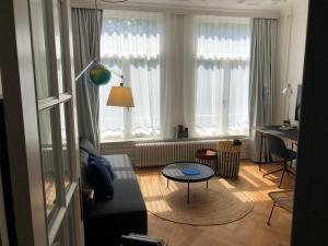 a living room with a couch and a table at Banzai City Amsterdam in Amsterdam