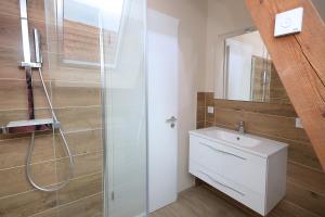 a bathroom with a sink and a shower at Remise 68 - Historisches Anwesen beim Maison 1775, mit Sauna, Wissembourg, Elsass in Ingolsheim