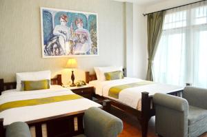 a hotel room with two beds and a painting on the wall at Casa Blanca Boutique Hotel - SHA Plus in Phuket +128 photos