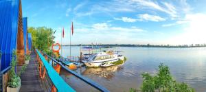 a boat is docked at a dock on the water at Cồn Phụng Retreats Mekong - Nature Island with Free Boat Shuttle & Fishing in Ben Tre +43 photos