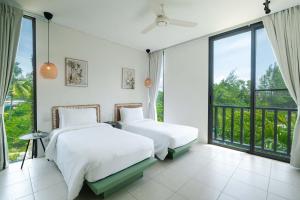 Ένα ή περισσότερα κρεβάτια σε δωμάτιο στο Stylish Penthouse at Bangtao Beach