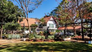 a house with a fence in front of a yard at Bann Tulip Khaoyai in Mu Si