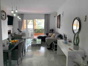 a living room with a couch and a table at Oasis Golf Apartment in Sitio de Calahonda