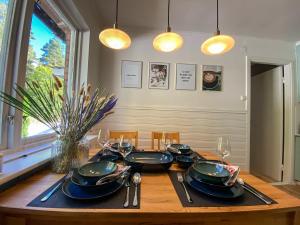 a dining room table with plates and utensils on it at FoRest House in Rosenfors
