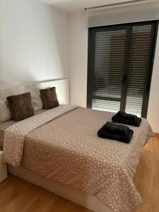 a bedroom with a bed with two pillows on it at Casa Mercaderes in Logroño