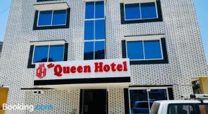 a queen hotel sign in front of a building at Hotel The Queen in Rawalpindi