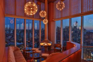 a restaurant with a view of a city skyline at The Standard, High Line New York in New York