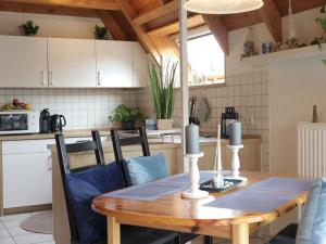 a kitchen with a wooden table and a dining room at Ferienhaus Poseidon in Dorum Neufeld