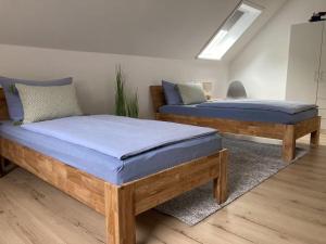 two beds in a room with blue sheets at Ferienhaus Heinrichs in Kappeler Niederstrich