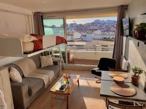 a living room with a couch and a bunk bed at Biarritz centre avec accès plage in Biarritz
