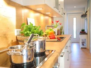 a kitchen with pots and pans on a counter at Ferienwohnung Wat Mutt in Dorum Neufeld +18 photos