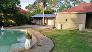a house with a swimming pool and a building at Chameleon in Kirkwood