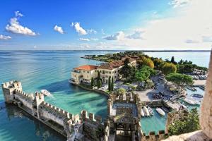 an aerial view of an island in the water at La Luce di Sirmione in Sirmione +29 photos