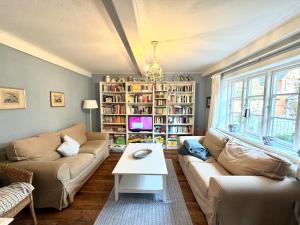 a living room with a couch and a table at Altes Standesamt Familienwohnung in Oldsum