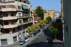 a city street with cars parked on the side of a building at Casa Amabile in Rome