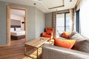 a living room with a couch and a room with a bed at La Boutique Hotel & Suites - Adults Only in Antalya
