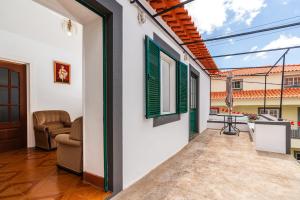 a hallway of a house with a living room at Casa Da Tia in Arco da Calheta