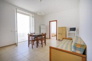 a living room with a bed and a table at Beach House , Torre Canne - Dori in Torre Canne