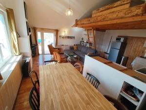a kitchen and living room with a table and chairs at La Maison Arcolan in Corps