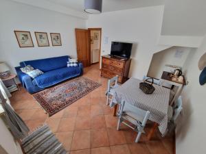 a living room with a blue couch and a table at La Locanda delle Idee Perugia in Perugia