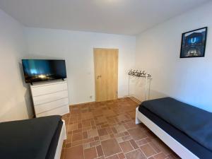a bedroom with a bed and a flat screen tv at Geräumige Monteurwohnung in Ibbenbüren