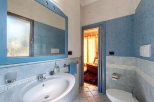 a bathroom with a tub and a sink and a mirror at Il Geco in Salice Salentino