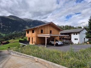 a house with a car parked in a parking lot at Studio 47 in Ernen