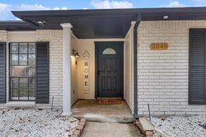 a front door of a house with a blue door at Luxurious 5BR 2BA Holiday Home with Pool, Grill, Sauna & Game Room in The Colony