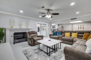a living room with a couch and a table at Luxurious 5BR 2BA Holiday Home with Pool, Grill, Sauna & Game Room in The Colony +51 photos