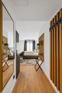 a living room with a bedroom and a bed at Nena Apartments München City in Munich