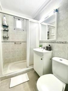 a bathroom with a toilet and a shower and a sink at Casa Orone in Valle Gran Rey