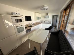 a kitchen with a table and some chairs and a counter at Gästehaus Auszeit in Riesa