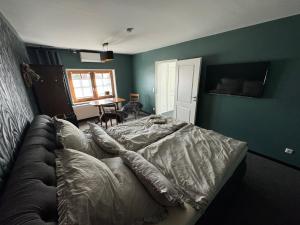 a bedroom with a bed and a couch at Gästehaus Auszeit in Riesa