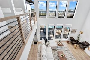 a living room with white furniture and large windows at Lakefront Luxe 6BR 4,5BA Holiday Home with Pool & Hot Tub in Rowlett