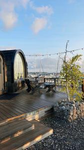 a wooden deck with a picnic table on a marina at Iglupark in Tallinn