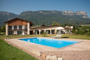 a house with a swimming pool in front of a house at Gutshof Ebner in San Paolo